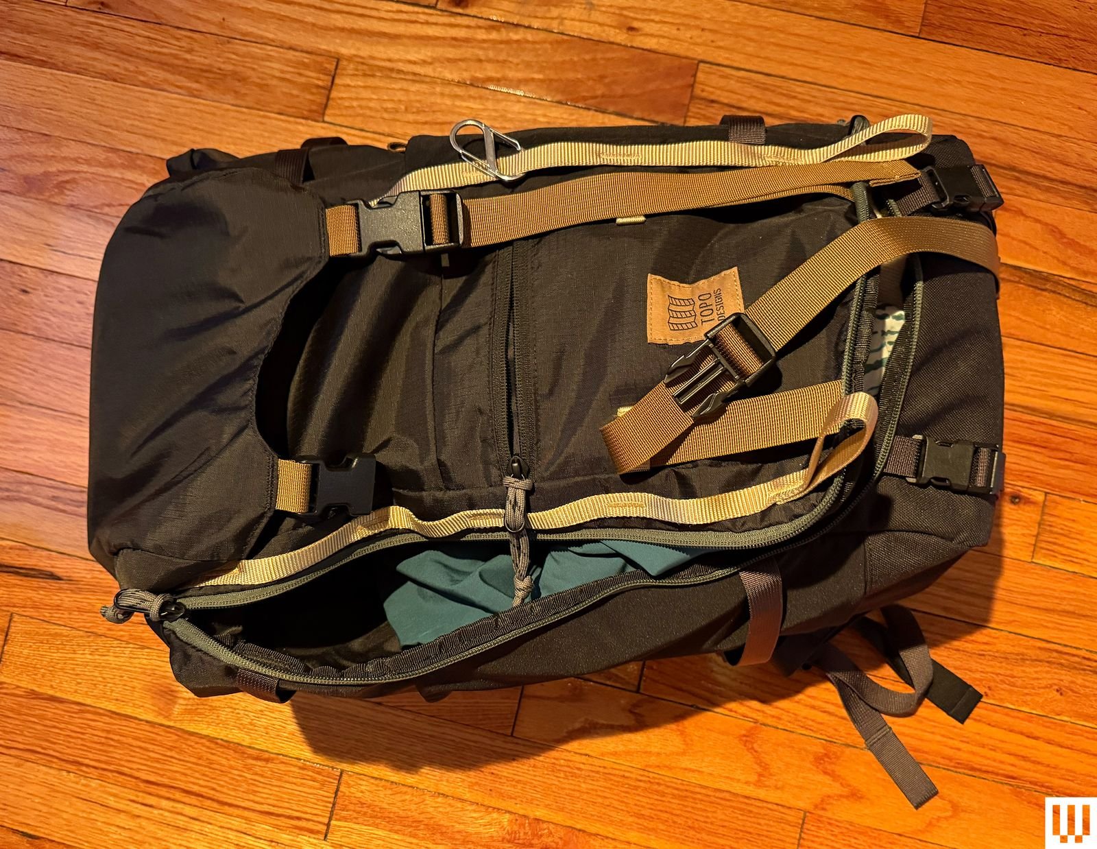 Backpack partially opened showing clothing inside