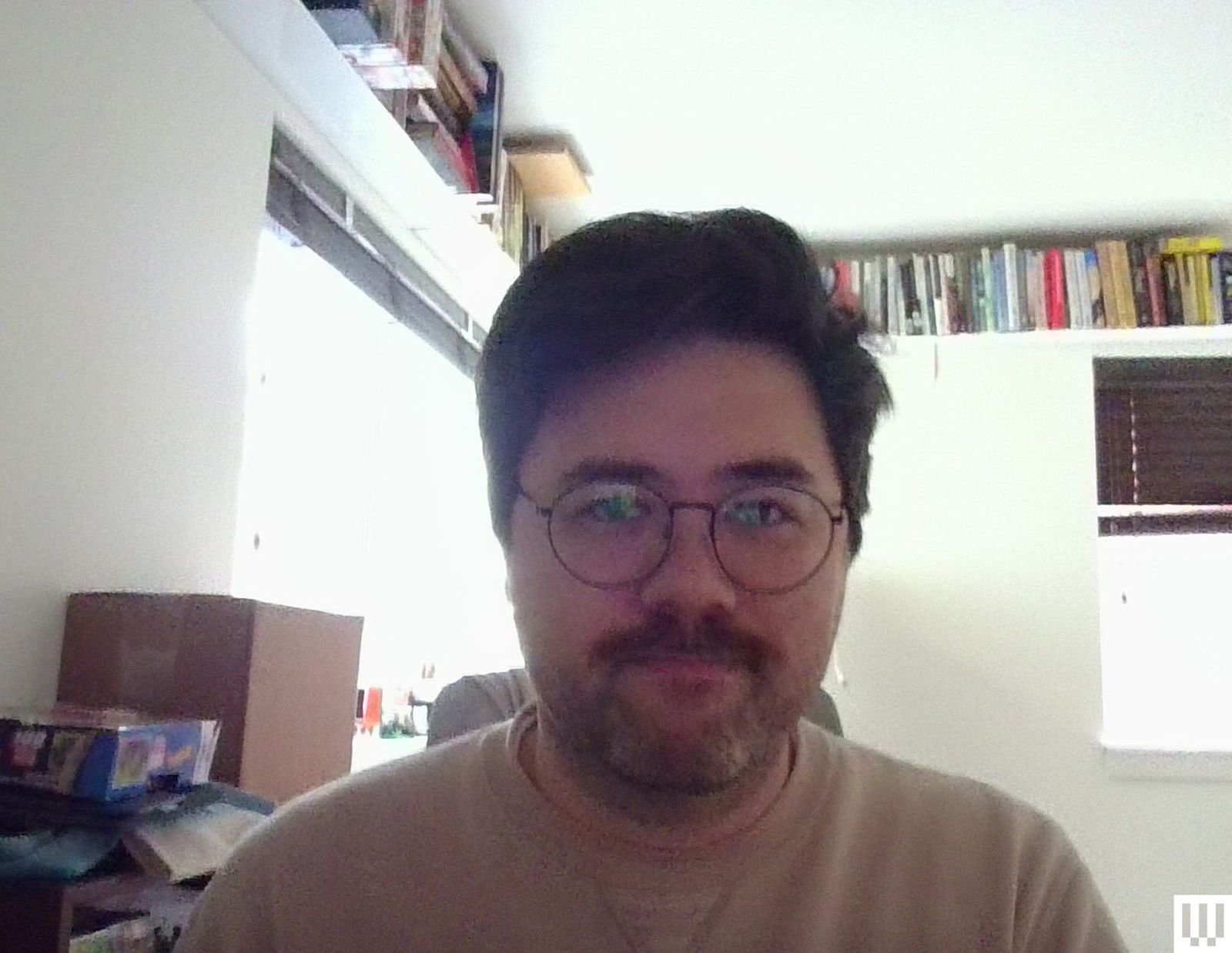 Person adjusting position near window for better lighting during video call