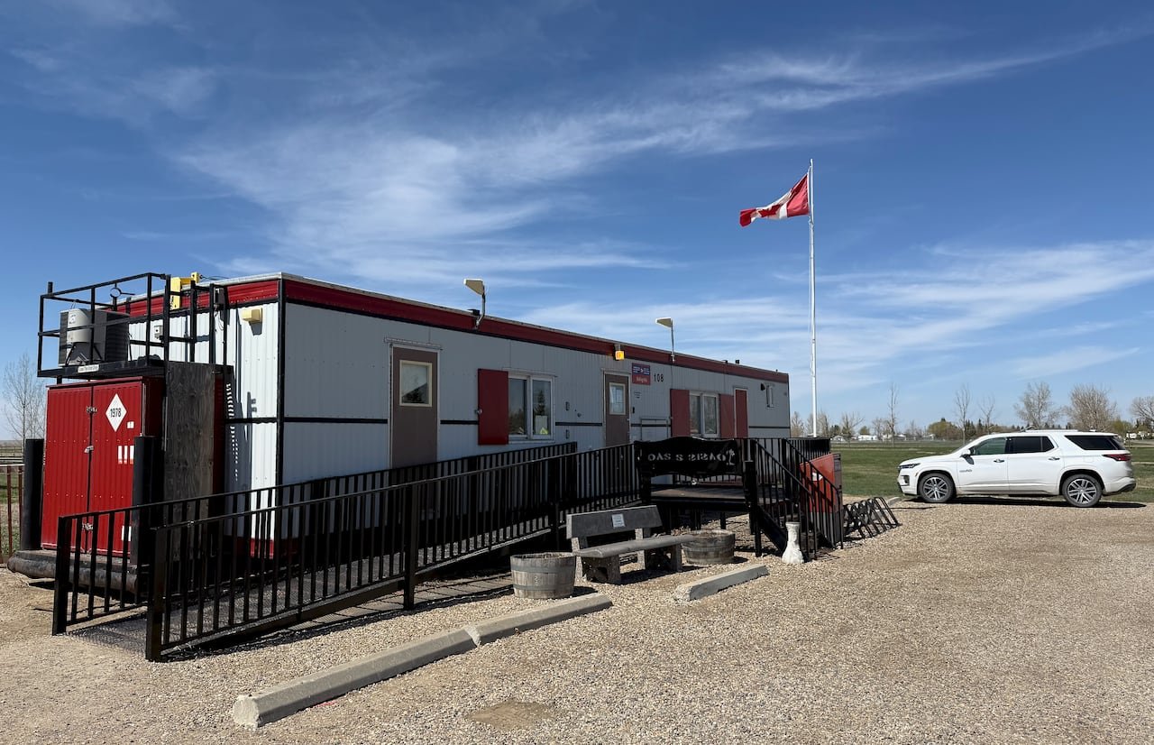 Canada Post trailer located in a gravel parking lot under clear blue sky