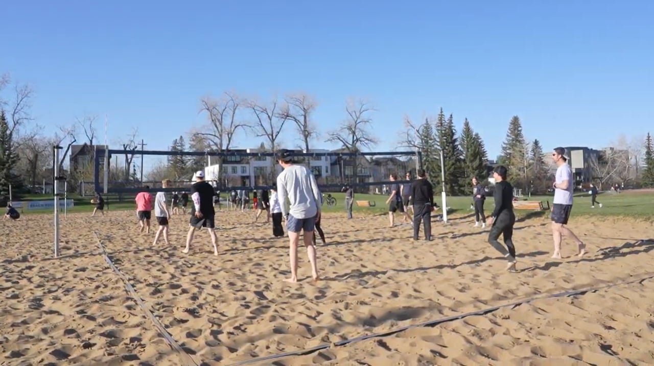 Group playing soccer together at urban park field