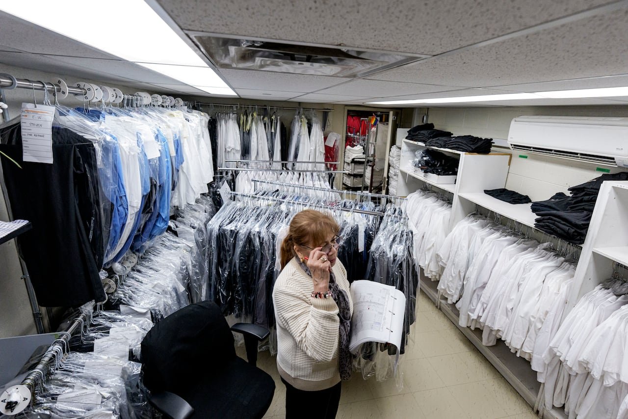 CN Tower staff member managing clothing racks