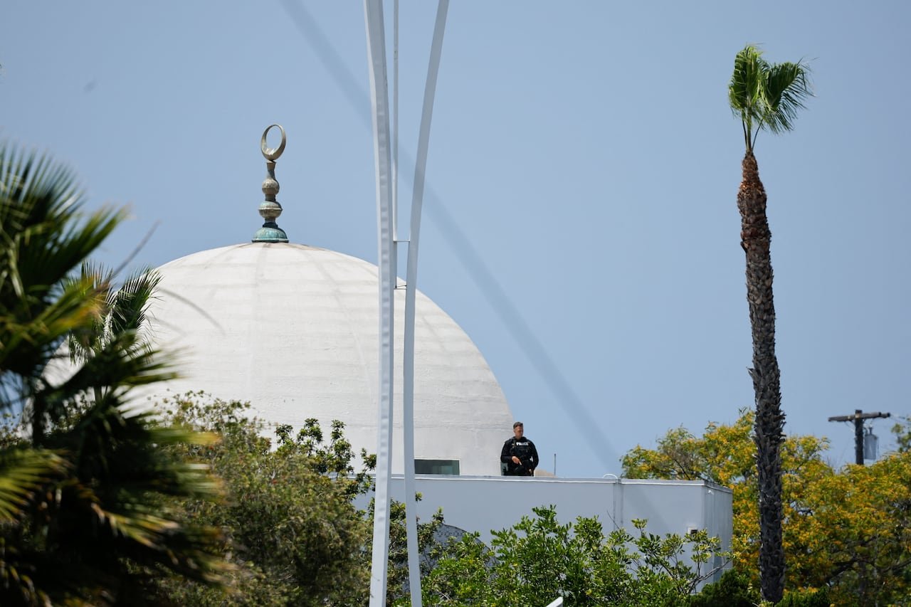 Armed officer standing guard at mosque balcony