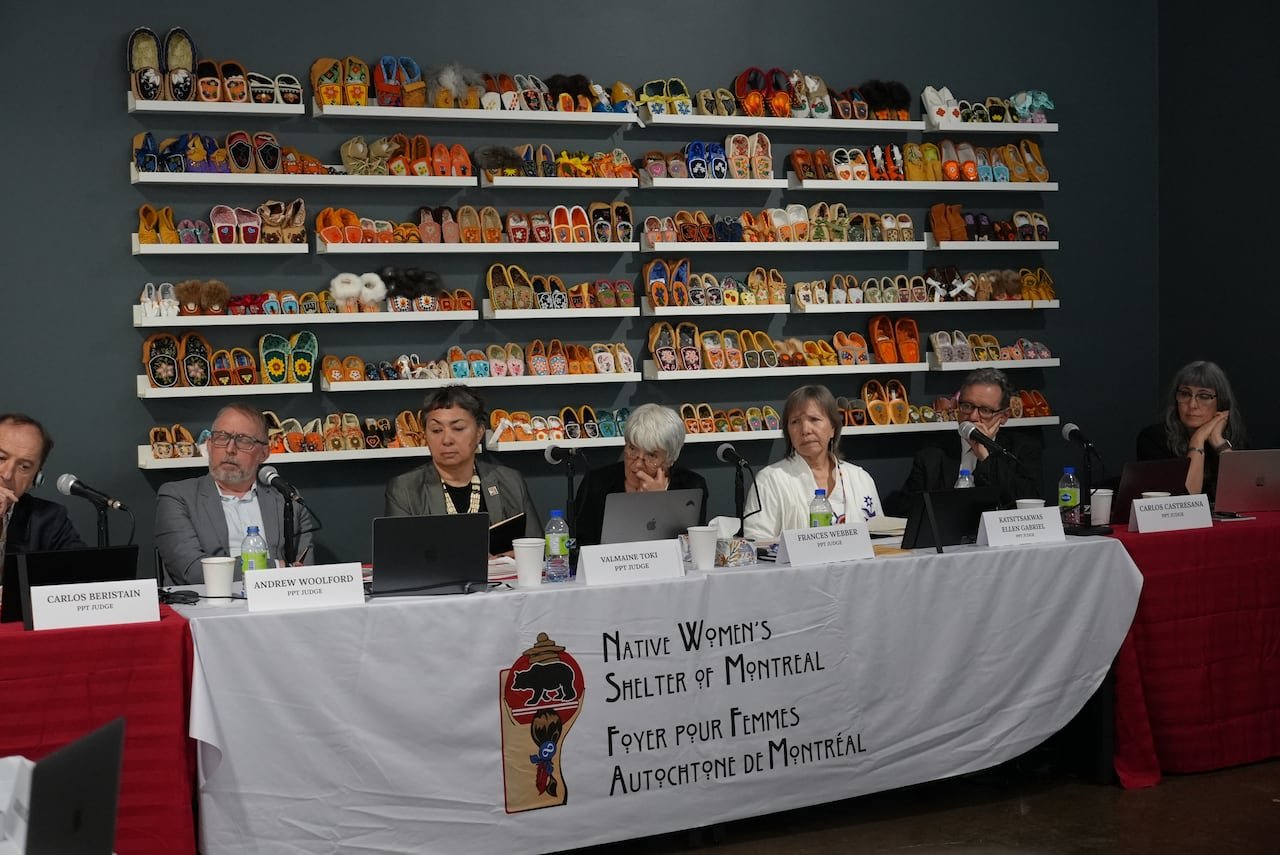 Seven judges seated at Permanent Peoples' Tribunal hearing in Montreal