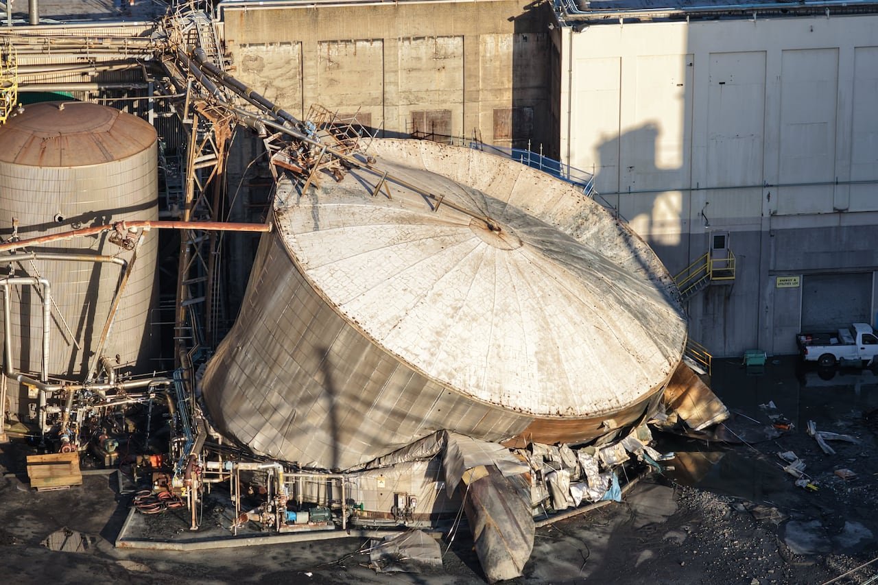 A heavily damaged chemical tank is seen in this aerial view.