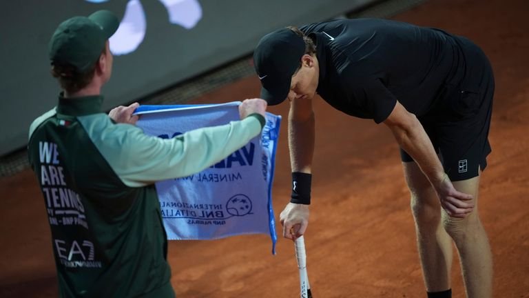 Jannik Sinner catching breath during match