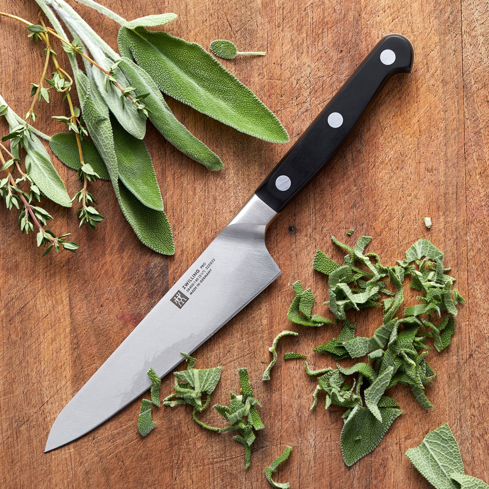 Zwilling Pro Prep Knife resting on wooden board