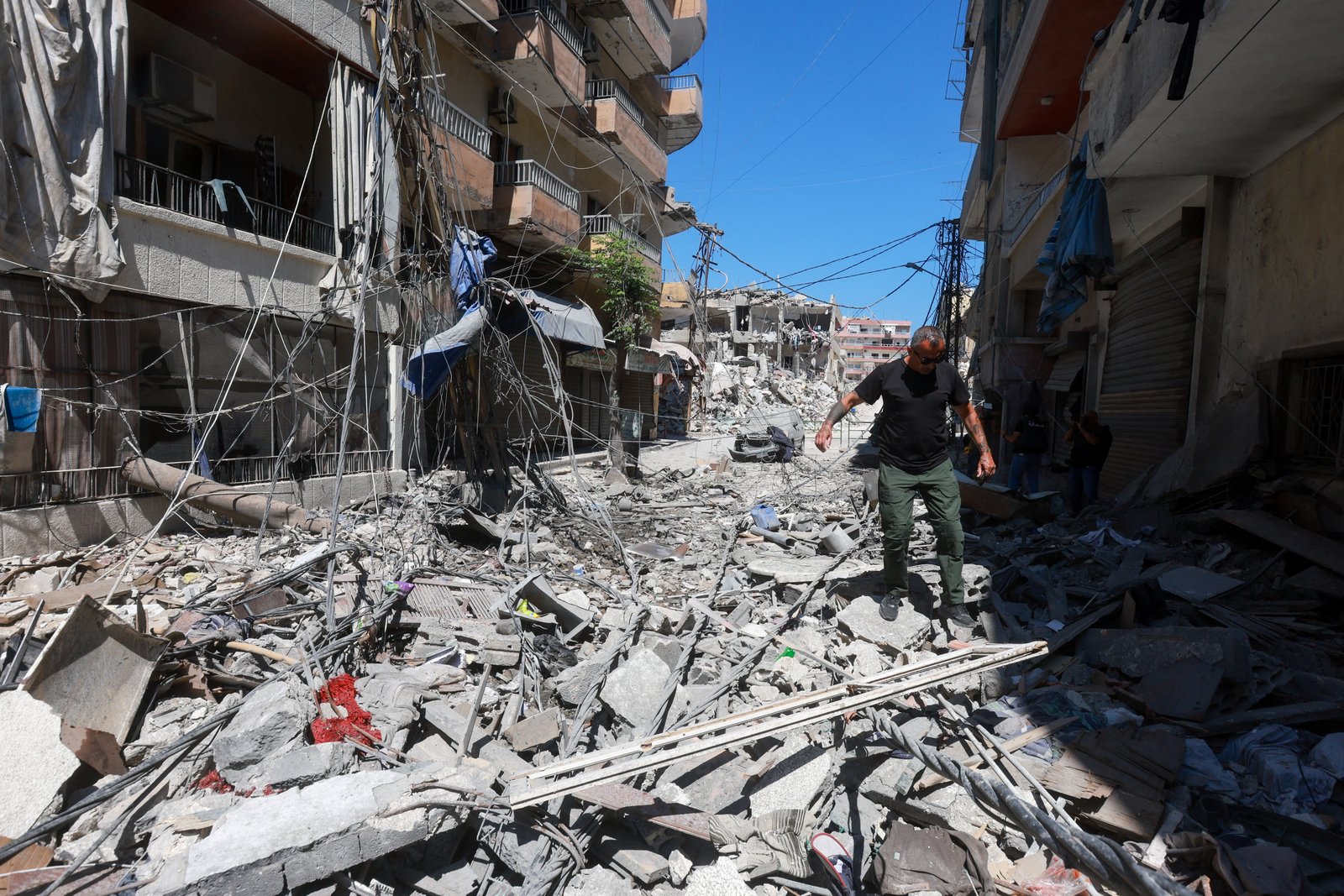 Man walking over debris after Israeli airstrike in Tire, Lebanon, June 12, 2026