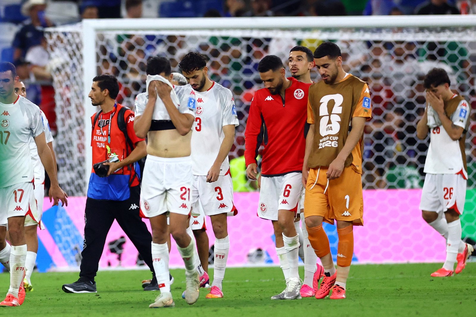 Tunisia players look dejected after defeat against Japan