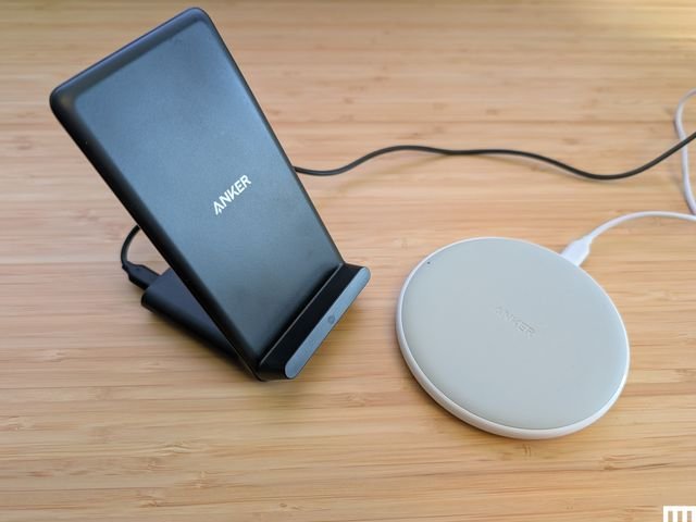 Side view of Anker PowerWave Pad and Stand,a black angled stand beside a white disc-shaped device