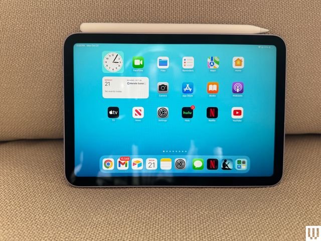 Front view of the Apple iPad Mini A17 Pro, a slim tablet, with the screen showing app icons and a stylus (digital pen) on top of it