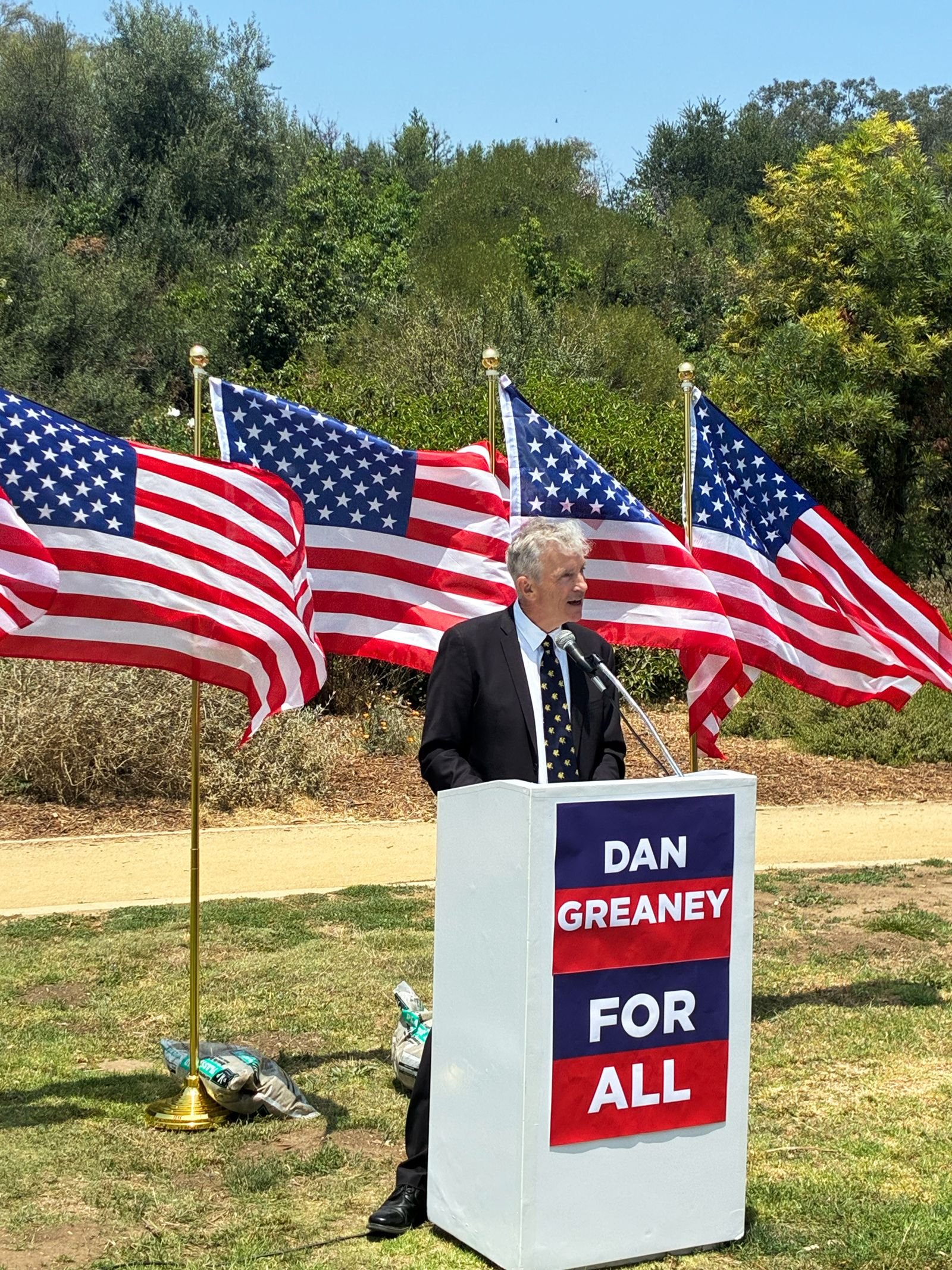 Dan Greaney speaking outdoors at campaign event