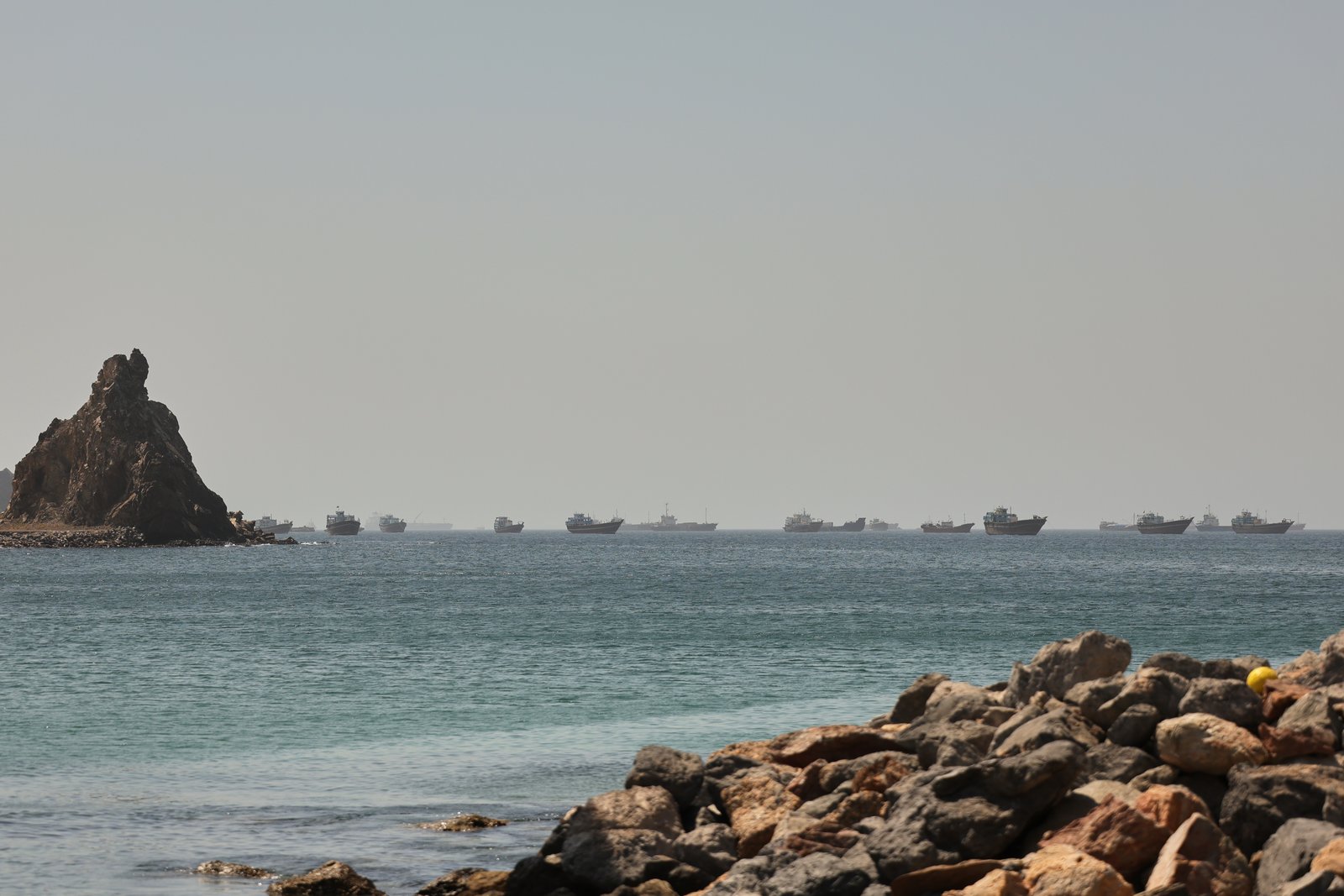Cargo and tanker vessels navigating shipping lanes near Strait of Hormuz in the Gulf of Oman