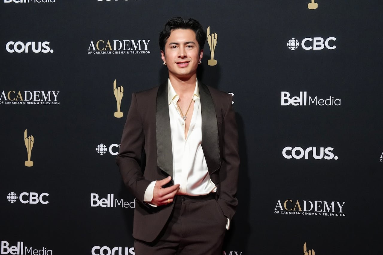 Hudson Williams confidently posing at red carpet event