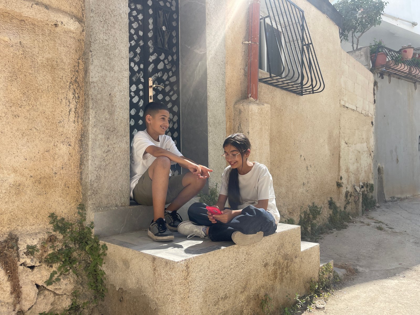 Children sitting together inside Dheisheh refugee camp