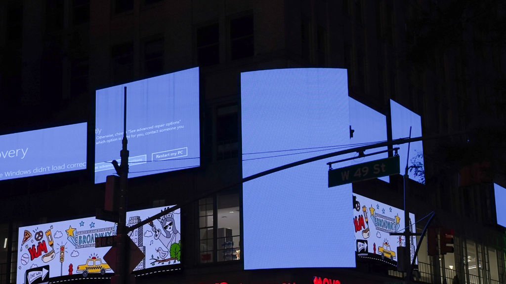 Times Square billboards displaying Windows blue screen error.
