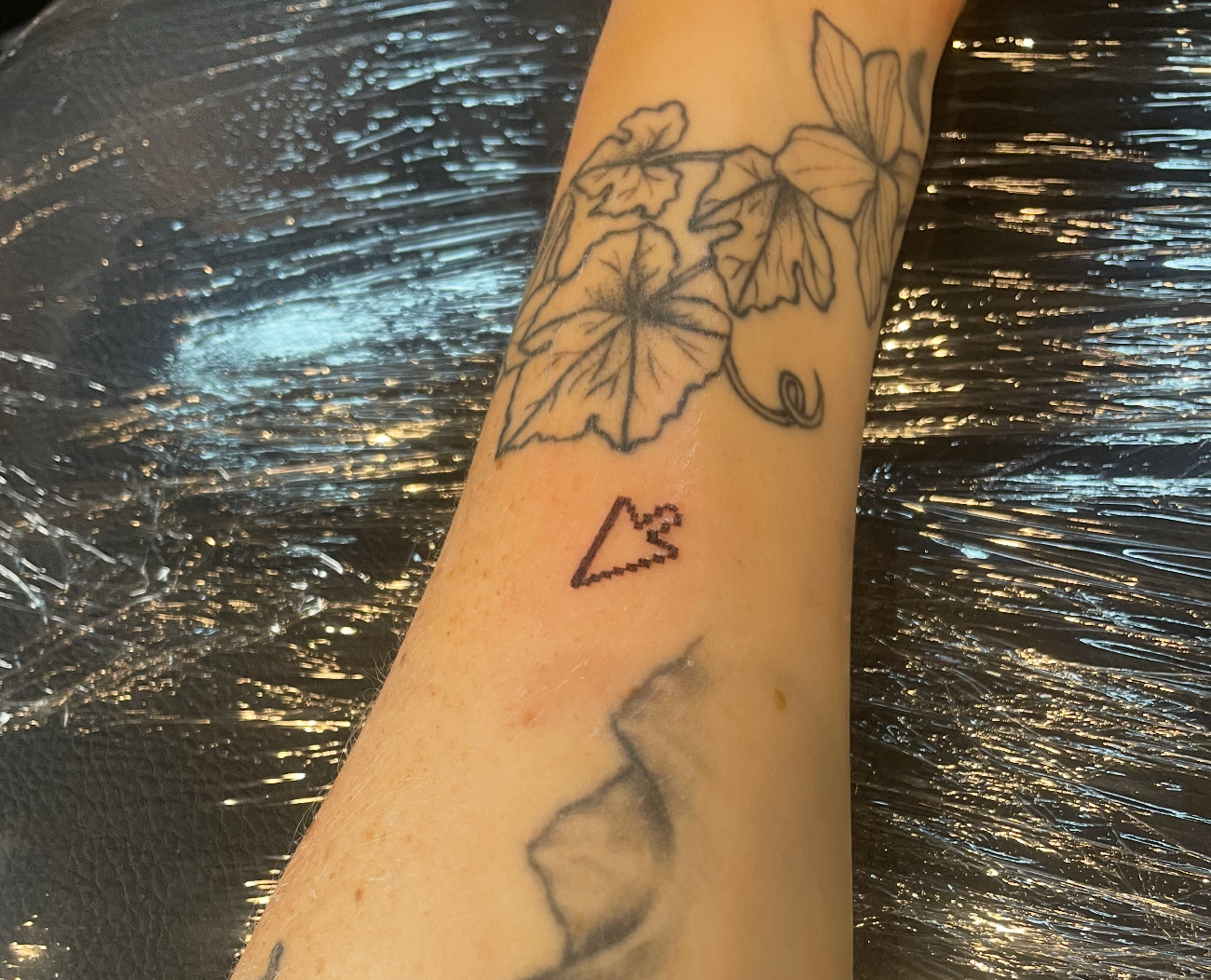 Maggie's pixelated cursor tattoo