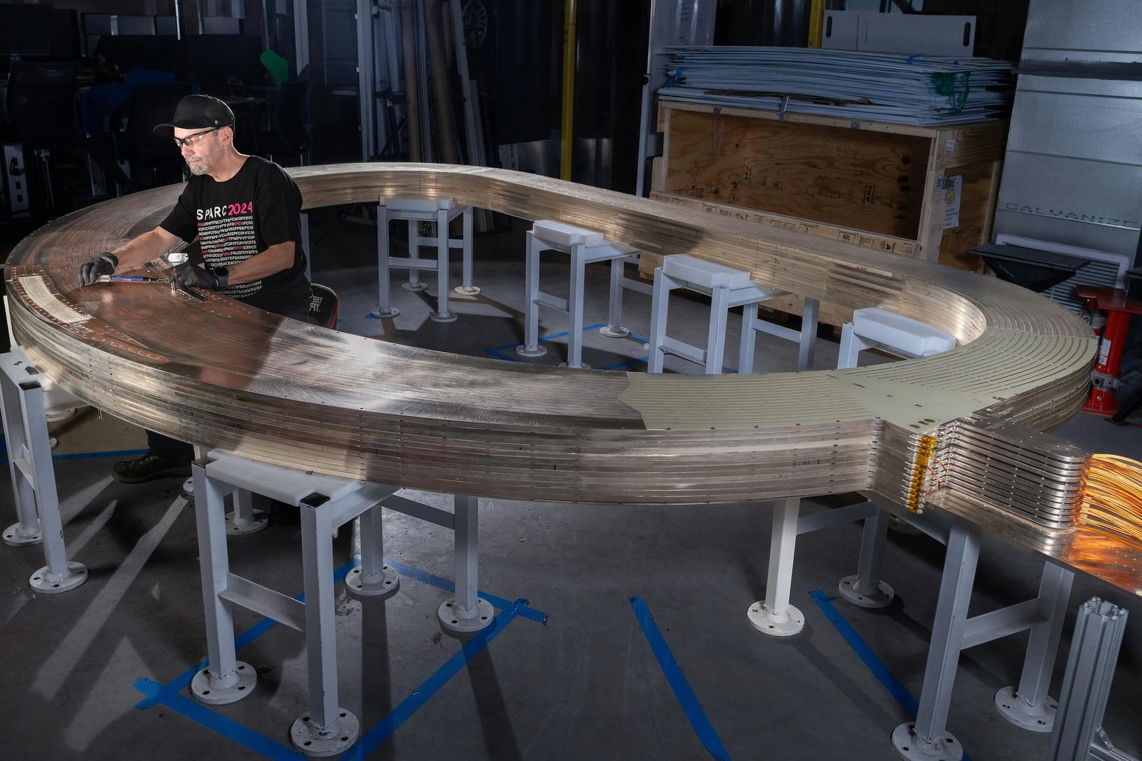 Engineer working inside superconducting magnet assembly