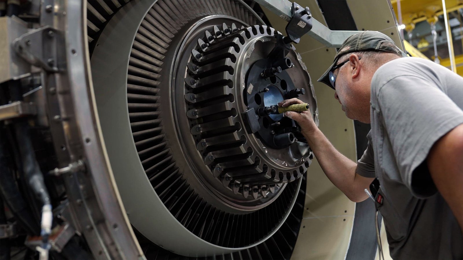 Technicians conducting thorough inspection on jet engine components