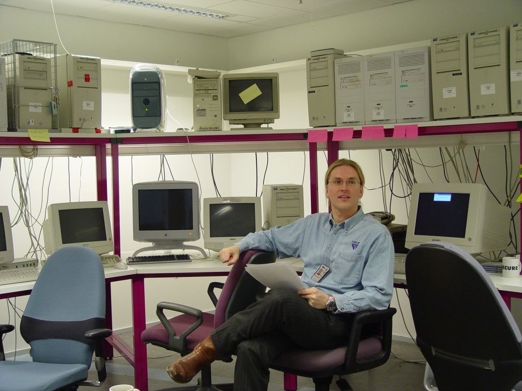 A younger Mikko Hyppönen surrounded by vintage computer equipment.