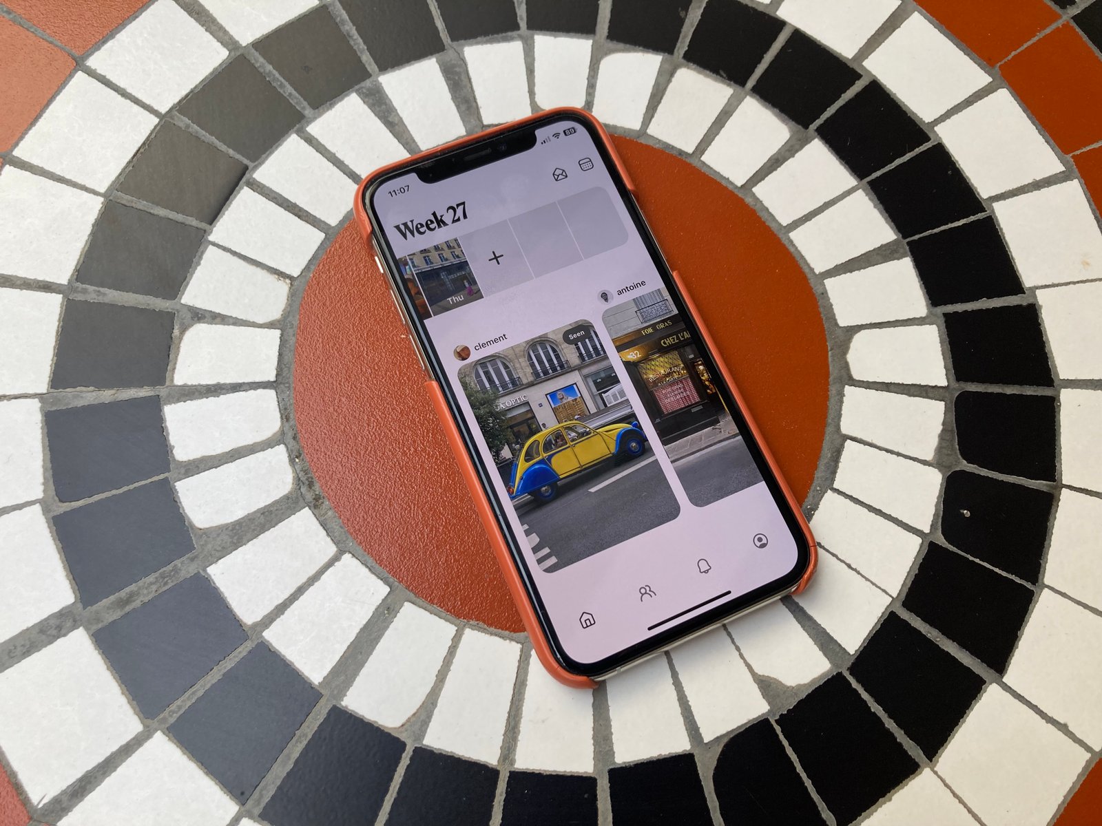 Retro app displayed on smartphone resting on tiled surface